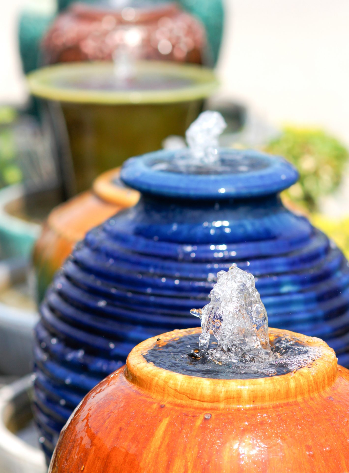 Water bubbling from colorful ceramic fountain pots