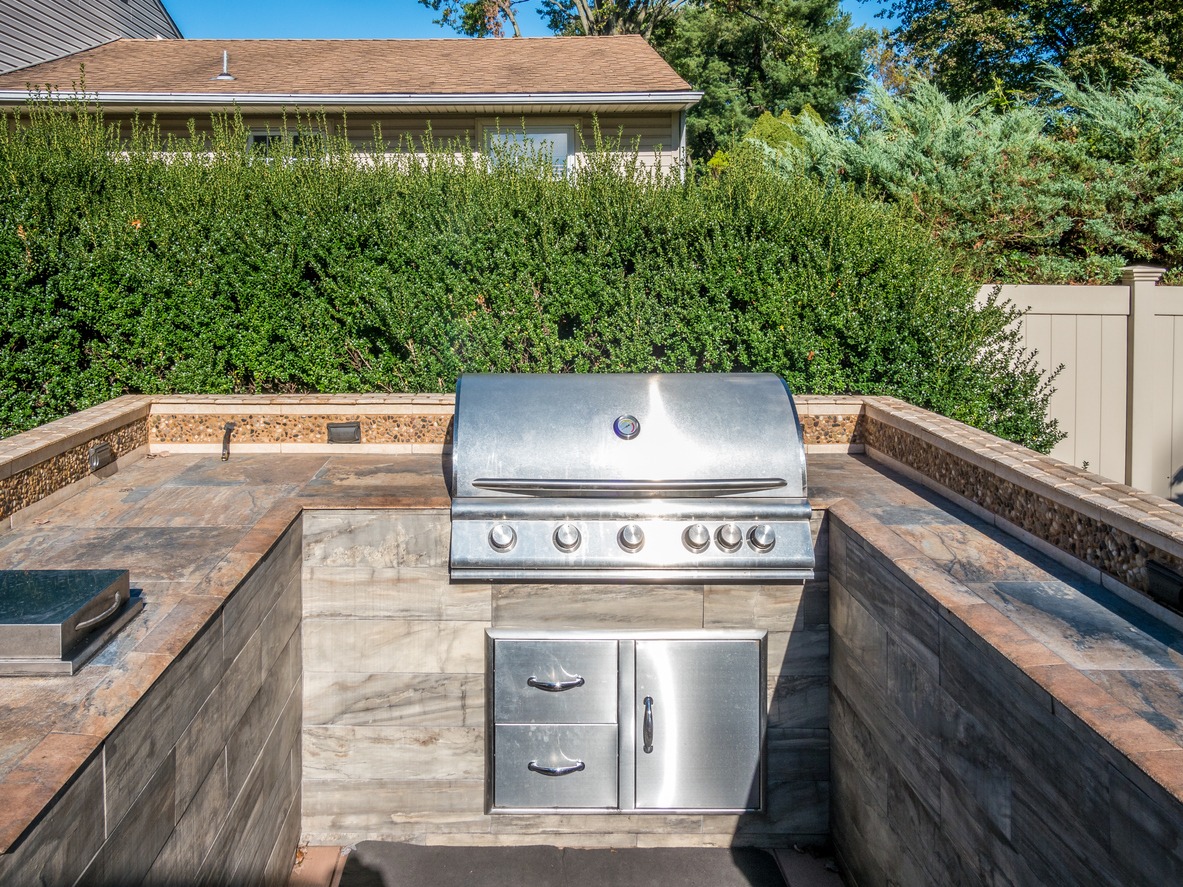 Built-in stainless steel grill in outdoor patio kitchen