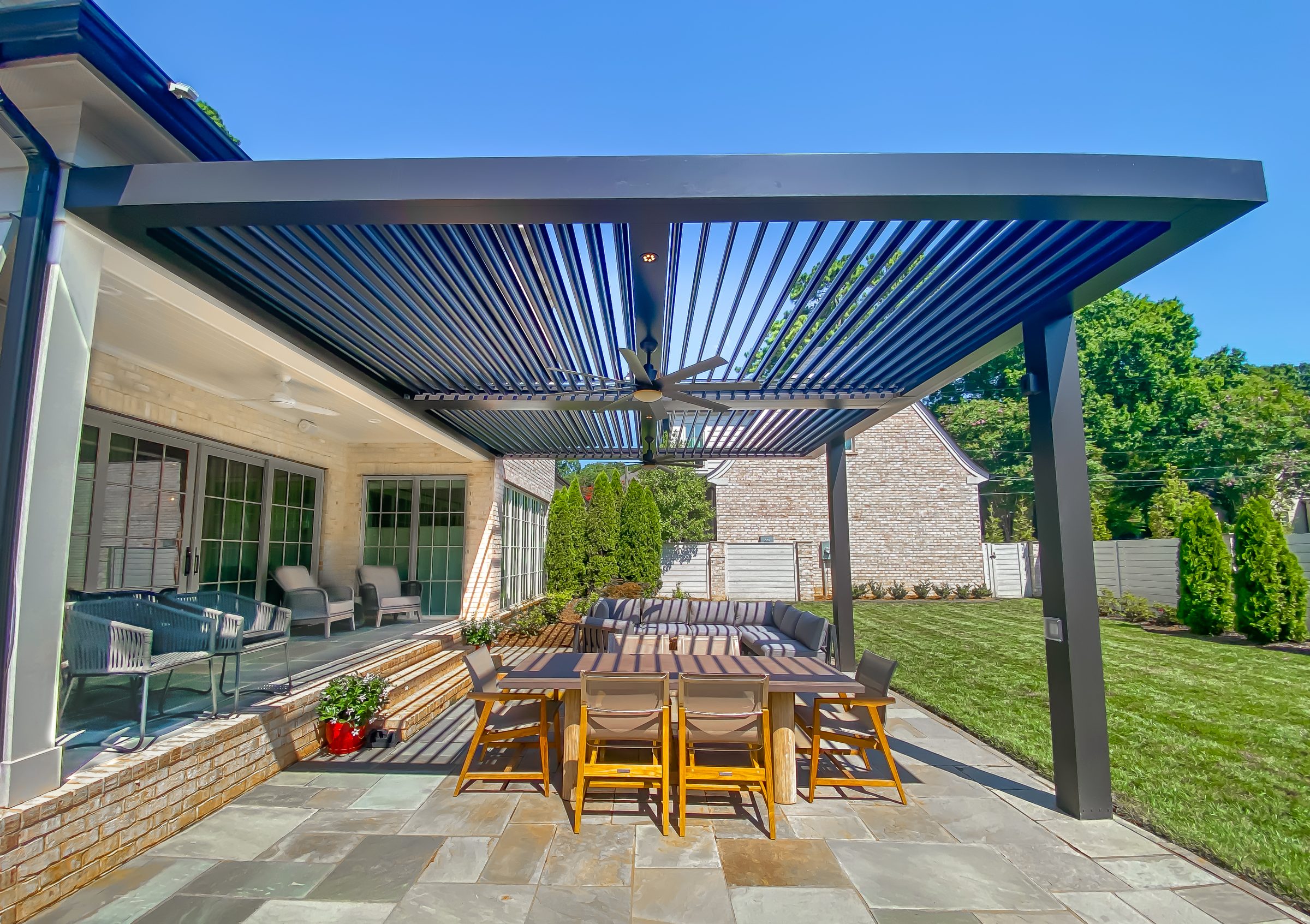 Modern backyard patio with pergola and dining set