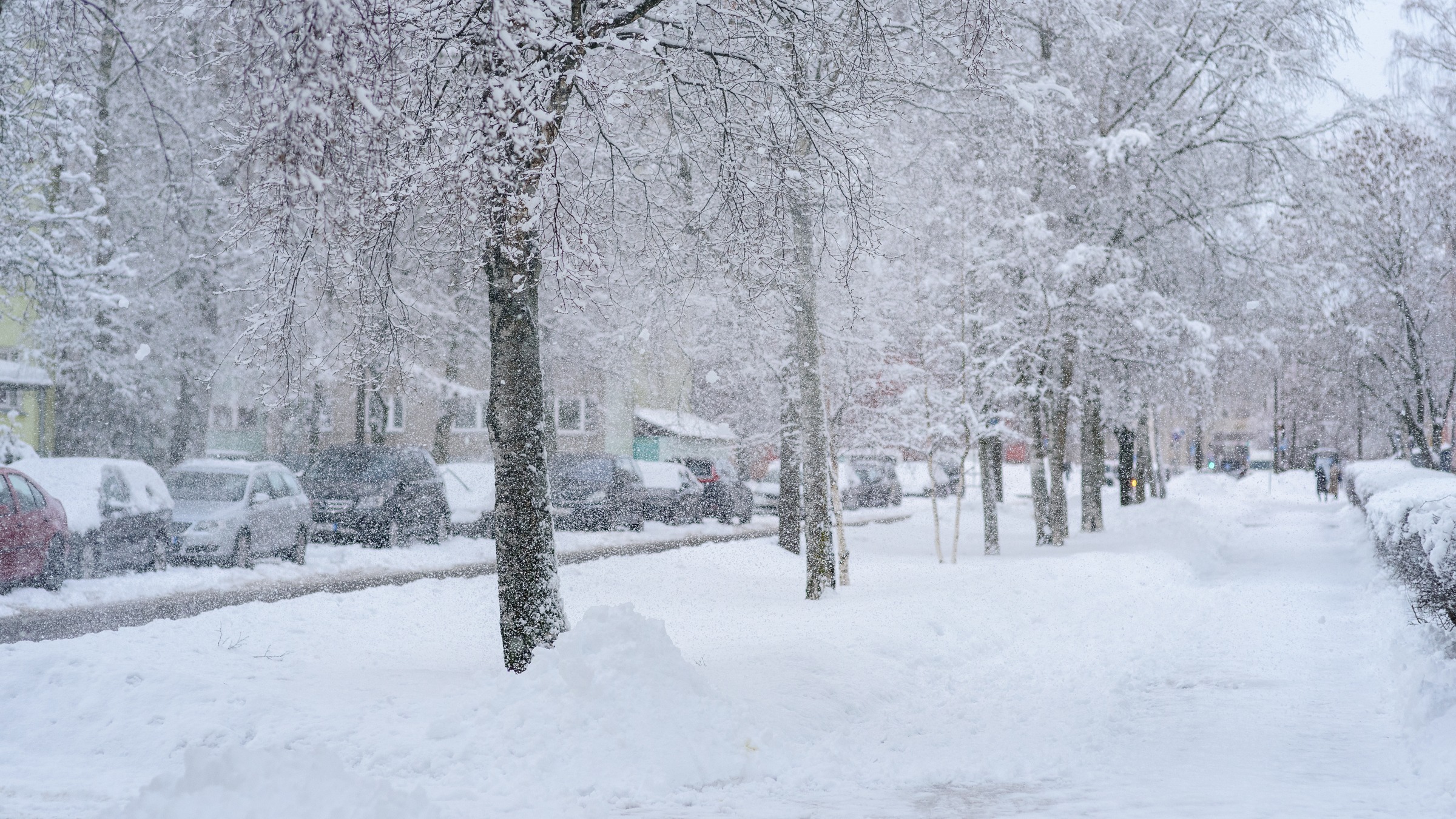 Snow covered street and sidewalk caused by a winter storm.